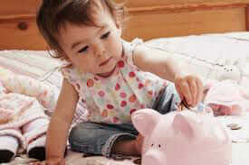 Girl adding Money to Piggybank