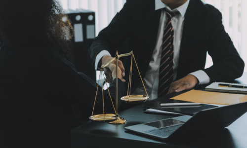 A living trust lawyer with a female client talking about the details of a trust they are working on.